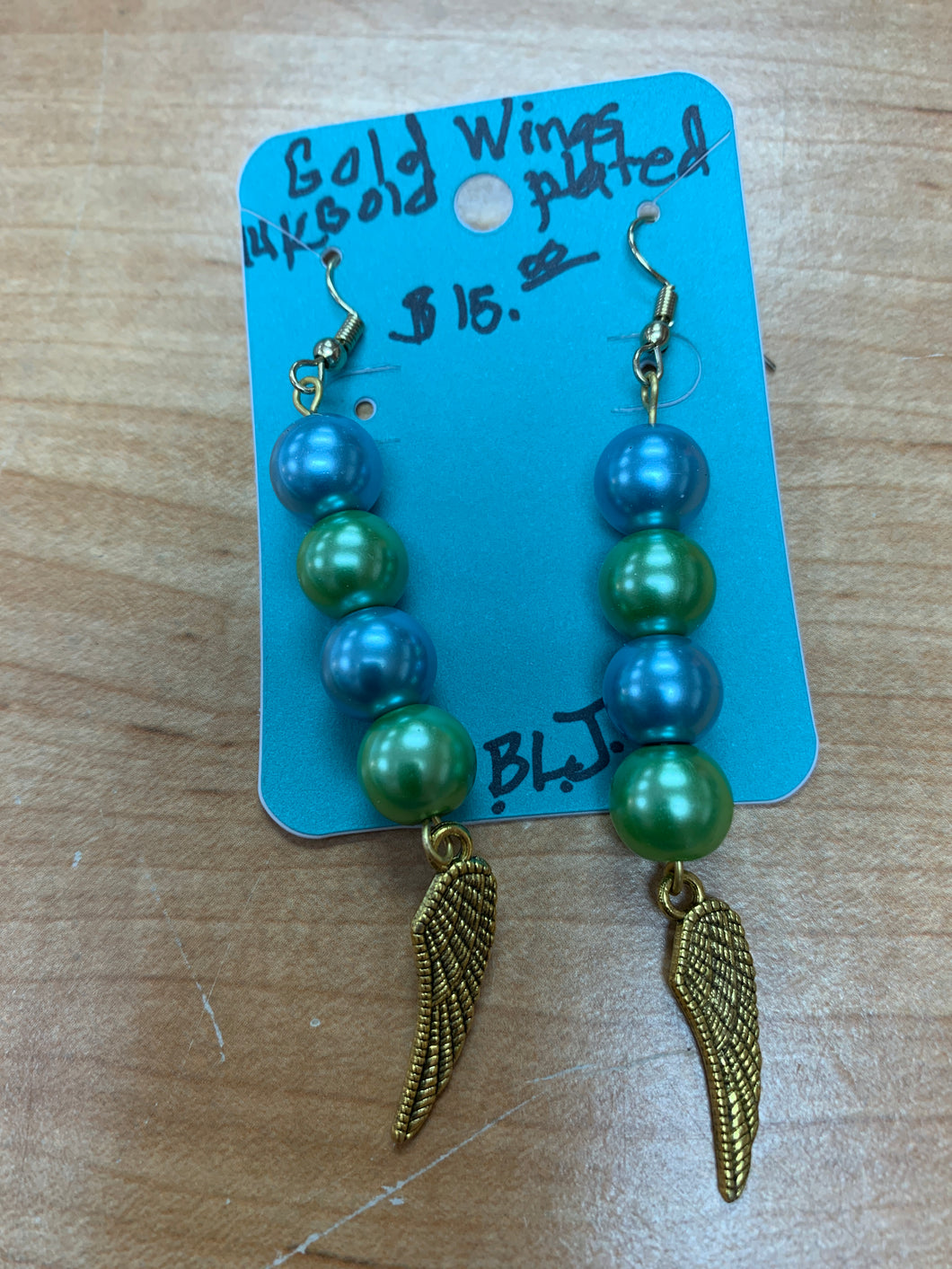 Handmade 14 k gold plated, light blue and green beads with 14k gold plated wings